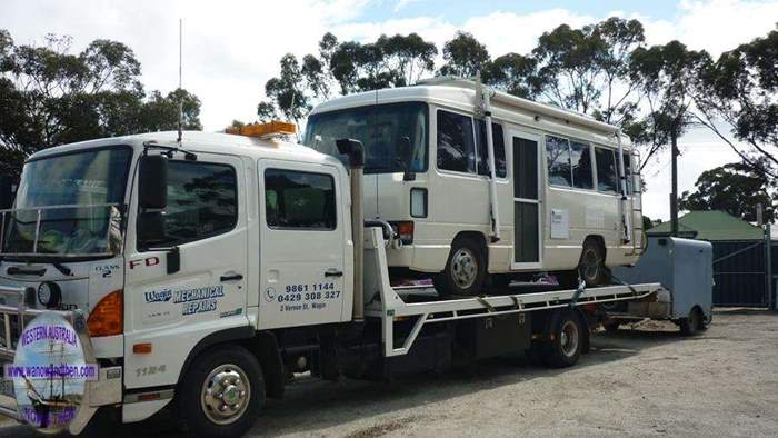 Coaster on a tilt-tray tow truck